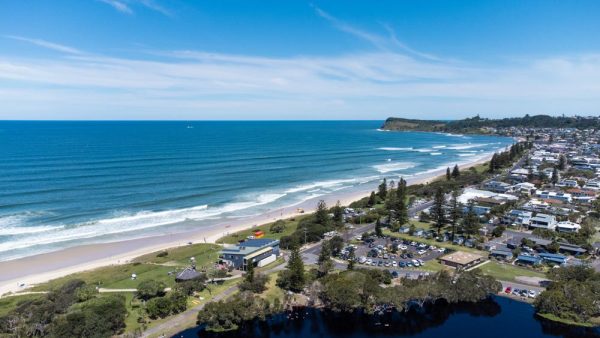 Aerial shot of Lennox Head Coastal area including Lennox Head beach, Seven Mile beach, Pacific Parade, Camp Drewe Road, a section of Lake Ainsworth and Pat Morton Lookout in the background.
