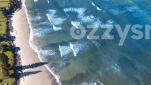 Clear waters from above at Seven Mile Beach in Lennox Head. You can also spot private entries to the beach surrounded by trees and rocks.