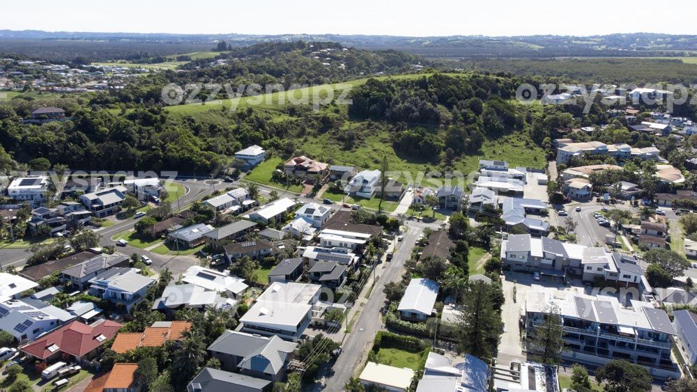 Aerial view of Residential area and hills in Lennox Head From above, a section of Lennox Head's residential area where you can spot the roundabout at the intersection of Ballina Street with Allens Parade, Rutheford Street, and the turn onto Park Lane.
