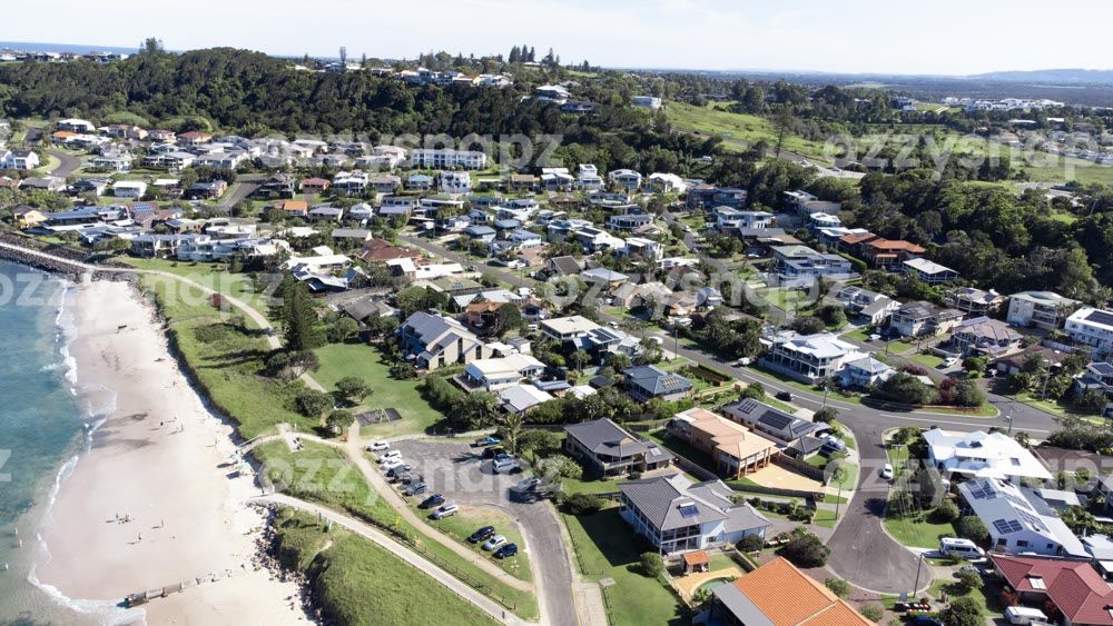 Aerial view of Residential area in Lennox Head next to Seven Mile Beach Part of Lennox Head's residential area next to Seven Mile Beach from above. You can spot the south entry to the beach and the parking area, Allens Parade, Tresise Pl, Dress Cir Dr, and The Coast Rd going up the hill in the background.