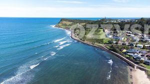 Wonderful aerial view of the homes in Lennox Head, the clear waters of the Pacific Ocean, the Pat Morton Lookout and the Lennox Head Point walking path.
