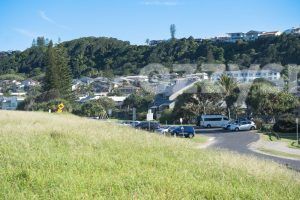 Shot of Rutherford St facing Lennox Head hills. You can see the trees swaying in the light breeze. 