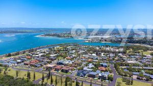 Gorgeous aerial shot from East Ballina, near Lighthouse Beach. In the distance, you may see Ballina Town centre, Missingham Bridge, North Creek, Shaws Bay and the Richmond River. There are people enjoying the water in boats and jet skis. You may also spot a few roads like Cedar Cres, Steele Street, Henderson Street, Foster Street, and McKinnon Street, among others.
