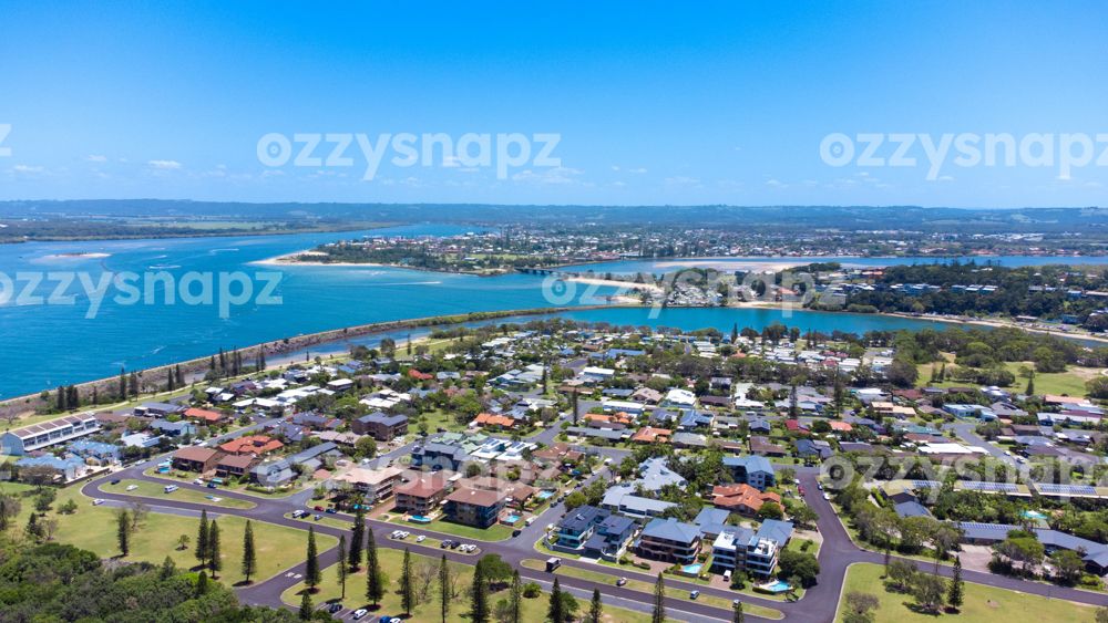 Aerial view from East Ballina looking towards to Ballina Gorgeous aerial shot from East Ballina, near Lighthouse Beach. In the distance, you may see Ballina Town centre, Missingham Bridge, North Creek, Shaws Bay and the Richmond River. There are people enjoying the water in boats and jet skis. You may also spot a few roads like Cedar Cres, Steele Street, Henderson Street, Foster Street, and McKinnon Street, among others.