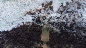 Ballina stock photo of Shelly Beach Rockpool at sunrise. The tranquil scene captures the rocks and ocean, at the picturesque sunrise.