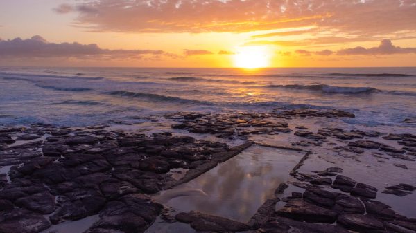 Stunning drone photography capturing the sunrise over the picturesque Shelly Beach rockpool