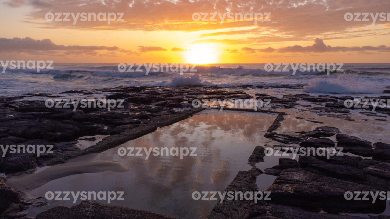 ozzysnapz_221296_low breathtaking aerial drone shot of the Shelly Beach rockpool at sunrise. Captures the wildness of the ocean and the calmness of the rockpool.