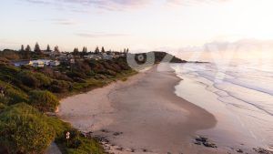 Downloadable stock image of Shelly Beach in East Ballina during sunrise with the Black Head lookout in the background.