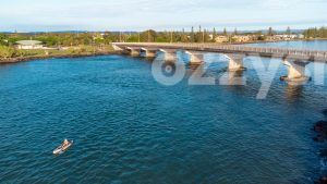 This aerial view captures the serenity and tranquillity of the morning, with a lone kayaker paddling along the river.