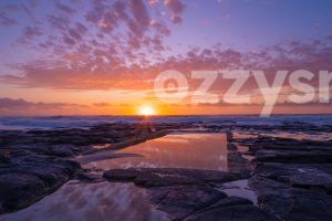 Stunning stock photo capturing the sunrise over the sea at Shelly Beach Rock pool in East Ballina.