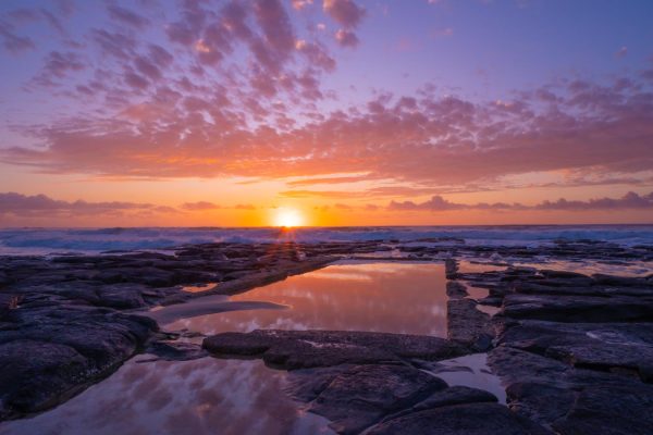 Stunning stock photo capturing the sunrise over the sea at Shelly Beach Rock pool in East Ballina.