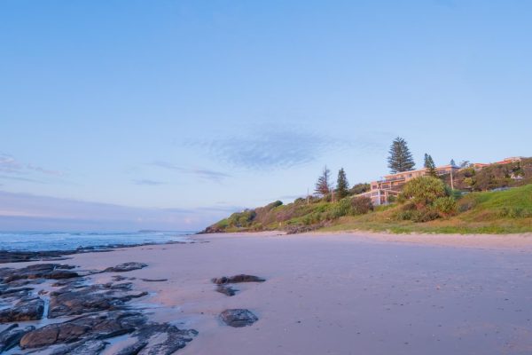 tranquil sunrise at Shelly Beach in East Ballina with the Shelly Beach Cafe nestled among the lush greenery.