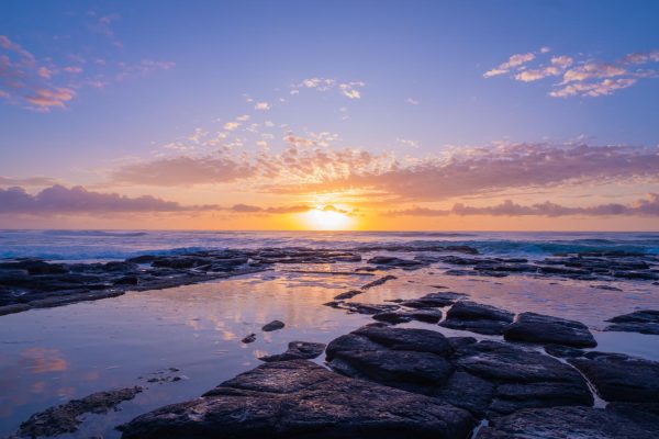 Stunning rock pool sunrise at Shelly Beach in East Ballina. This high-quality, downloadable stock image captures the colourful sky and serene reflection.