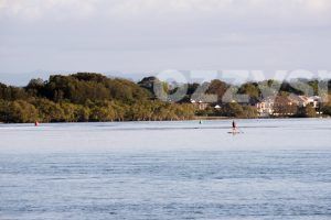 Stock image showcasing calm waters of North Creek in Ballina during sunrise while cruising on a stand-up paddle board.