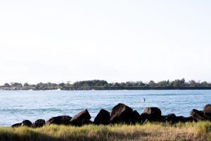 Lifestyle shot capturing a person kayaking ballina richmond river during sunrise.