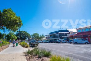 Downloadable stock image of a greeny Byron Bay town centre walk path, including the Byron Theatre and Community Centre.