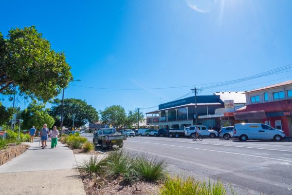 Downloadable stock image of a greeny Byron Bay town centre walk path, including the Byron Theatre and Community Centre.