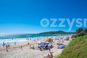 Vibrant and bustling atmosphere of Byron Bay's Main Beach. Perfect for travel or tourism projects.