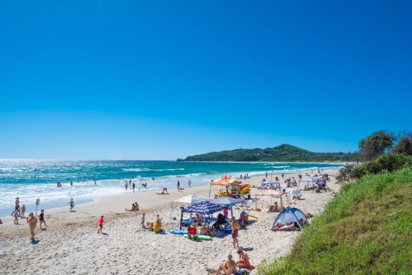 Vibrant and bustling atmosphere of Byron Bay's Main Beach. Perfect for travel or tourism projects.